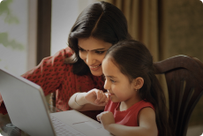 Female looking at computer with child